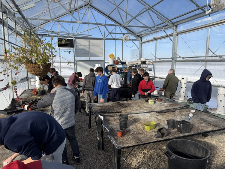 students planting seeds in the greenhouse 