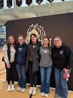 Students posing in front of SMSU sign.