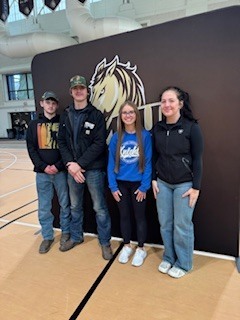 Students posing in front of SMSU sign.