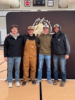Students posing in front of SMSU sign.