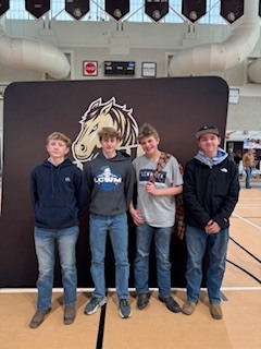 Students posing in front of SMSU sign.