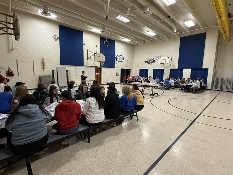 staff members sitting and listening to instructions before training