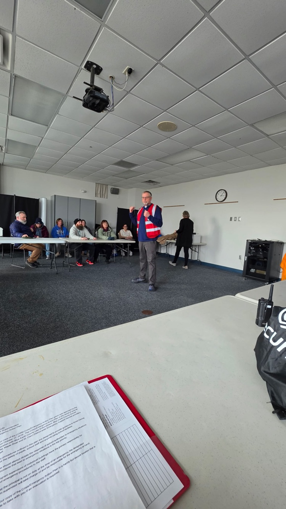 secondary staff members sitting and listening to instruction in open room