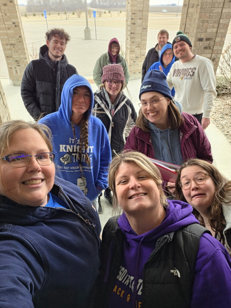 staff posing and smiling at camera while they wait in the process