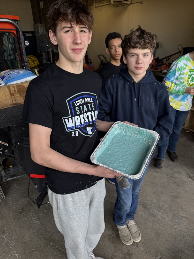 students frying pancakes on a griddle 