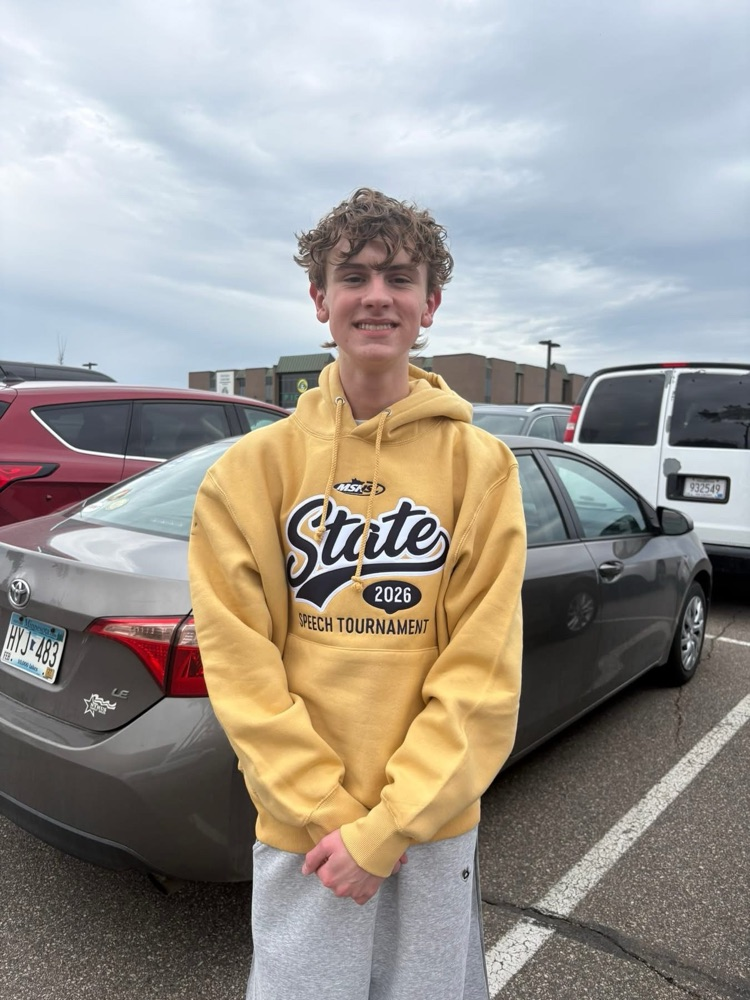 student with state speech shirt on in a parking lot  