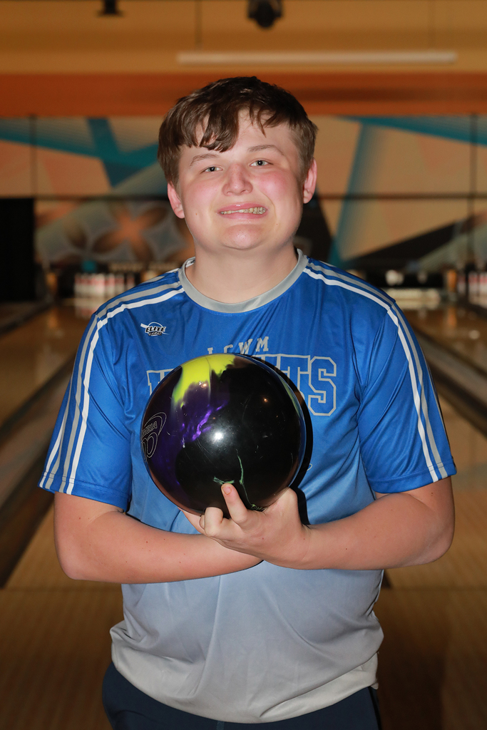 Peyton holding a bowling ball smiling