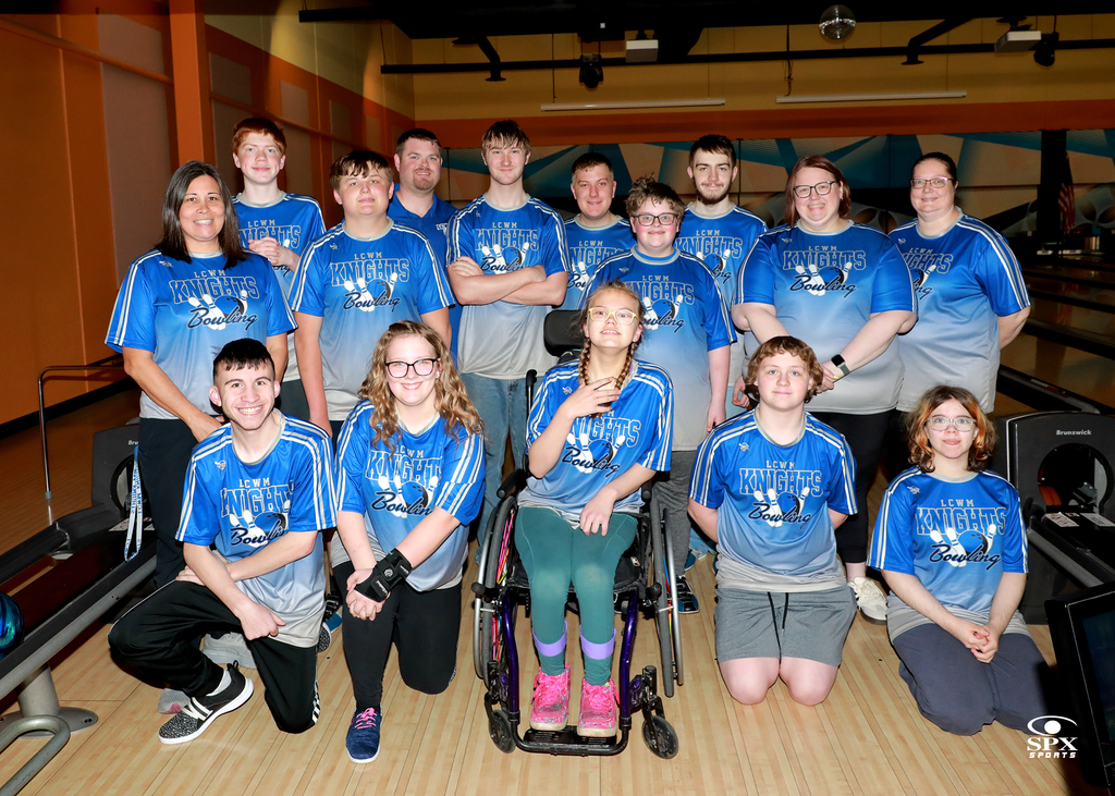 bowling team standing and kneeling in the bowling alley