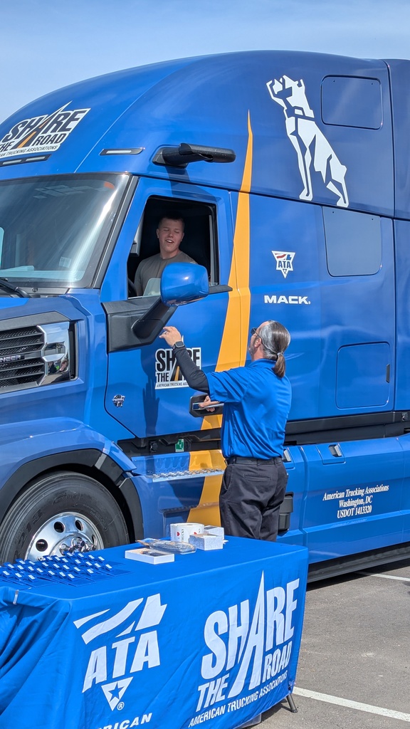 Student sitting in the driver seat of a semi to experience the blindspots like a semi driver does. 