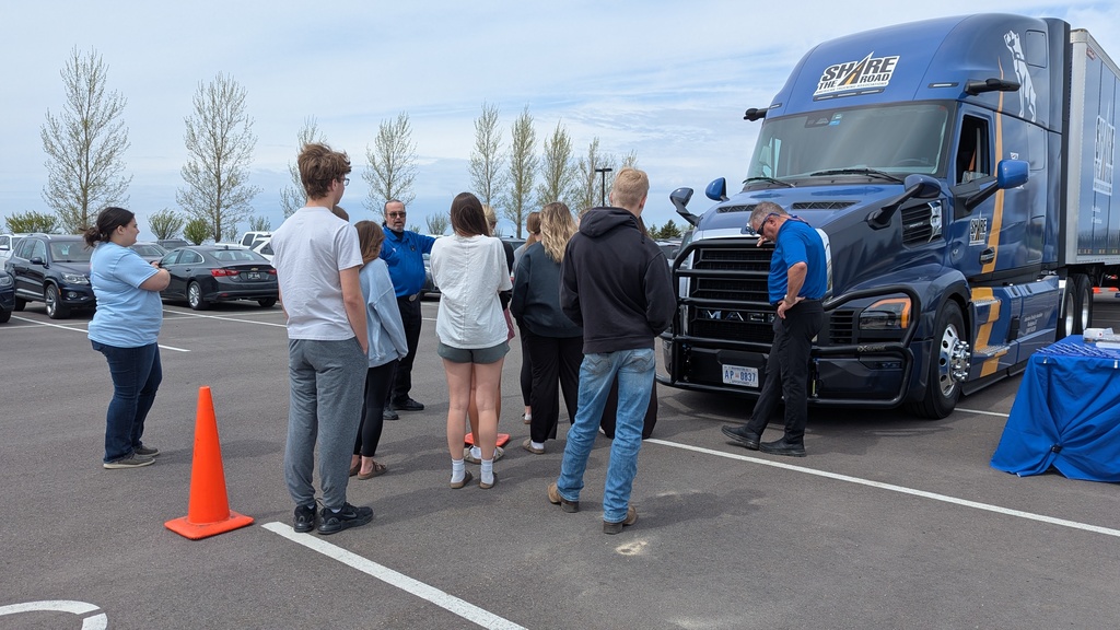 Students lined up outside of a semi, learning about semi blindspots.  