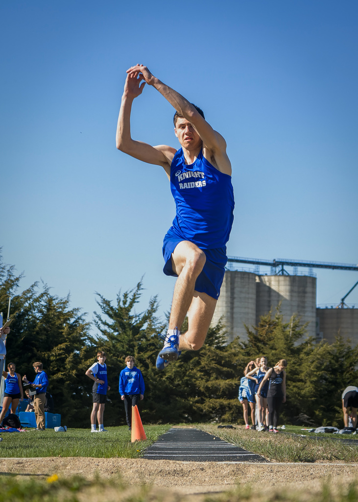student running and leaping the triple jump run.
