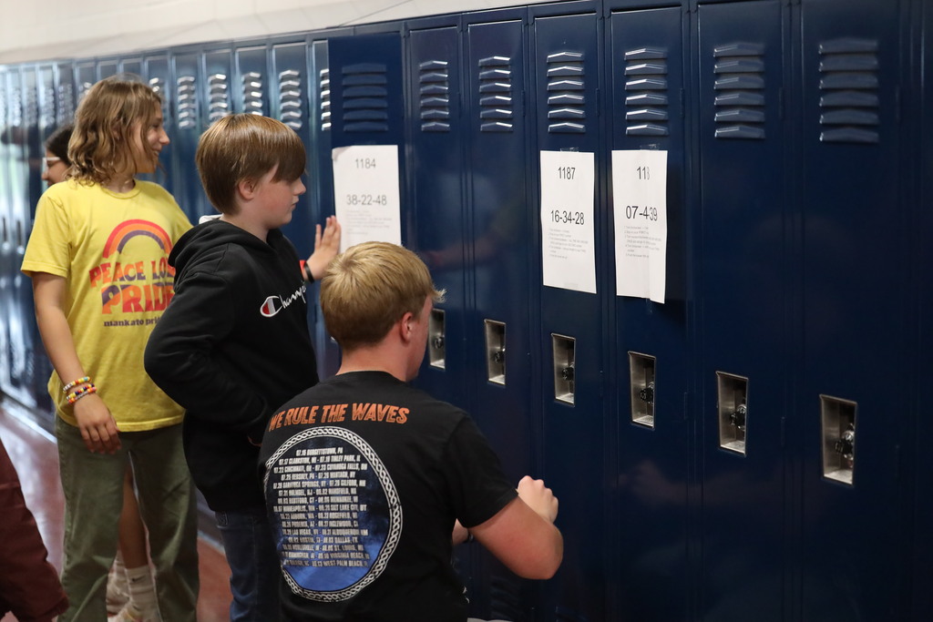 Students walking down and looking into classrooms.