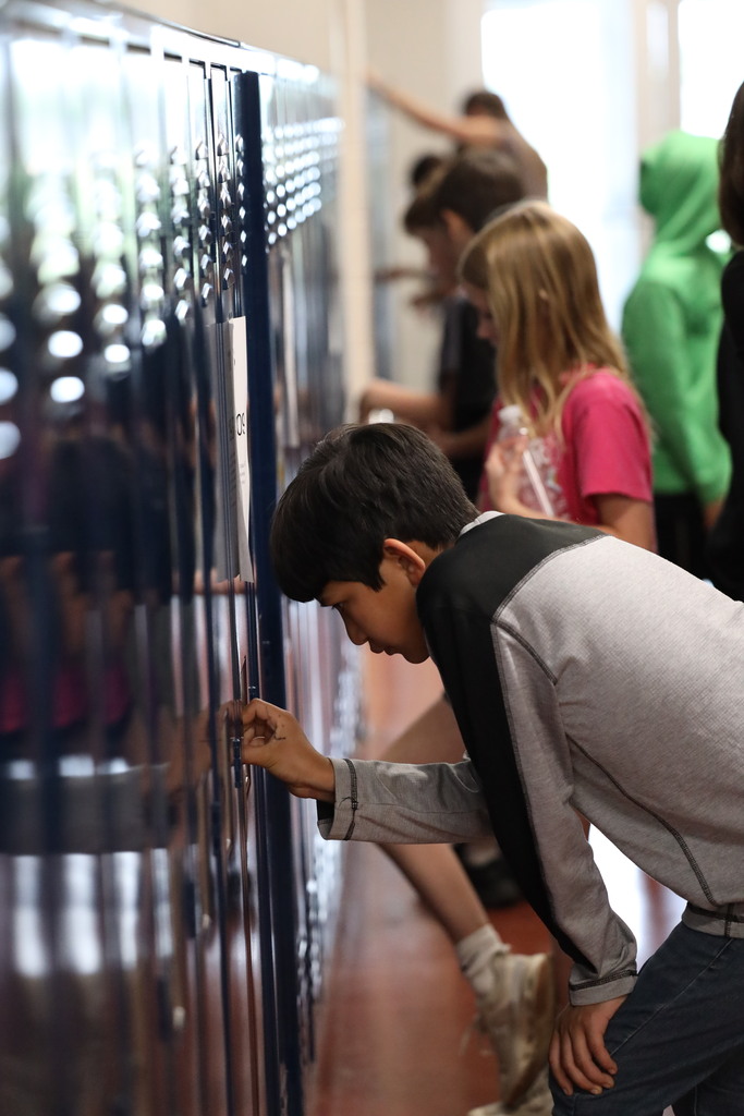 Students walking down and looking into classrooms.