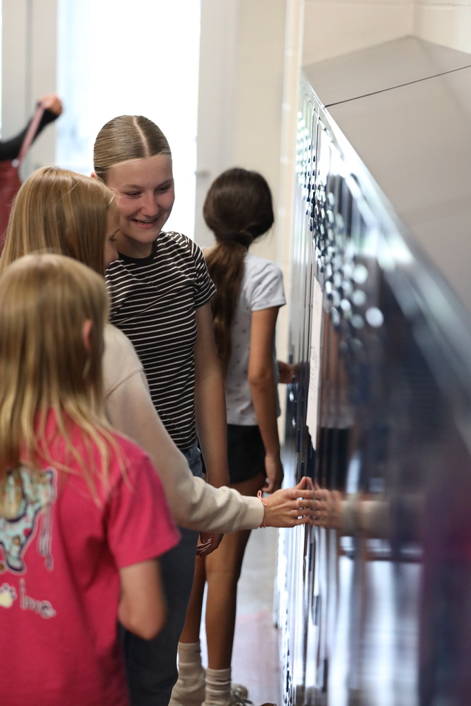 Students walking down and looking into classrooms.