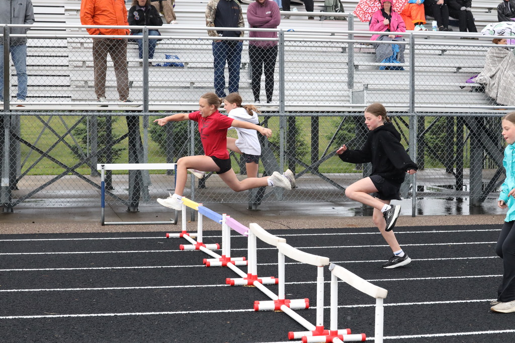 Student running hurdles 