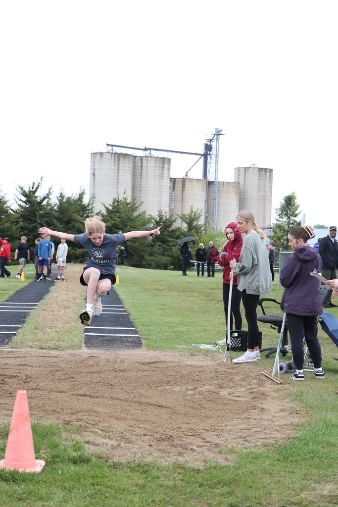 girl doing the running long jump.  Mid air jump.