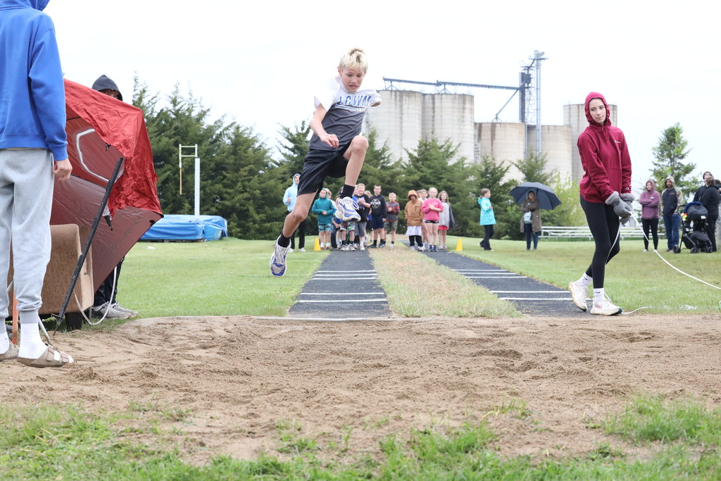 boy doing the running long jump.  Mid air jump.