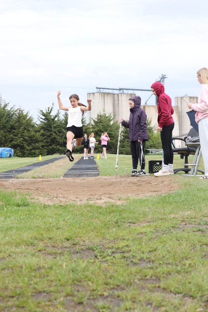Girl doing the running long jump, mid air.