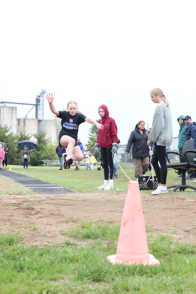 girl doing the running long jump.  Mid air jump.