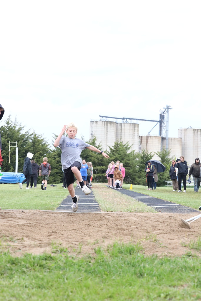 Boy doing the running long jump.  Mid air jump.