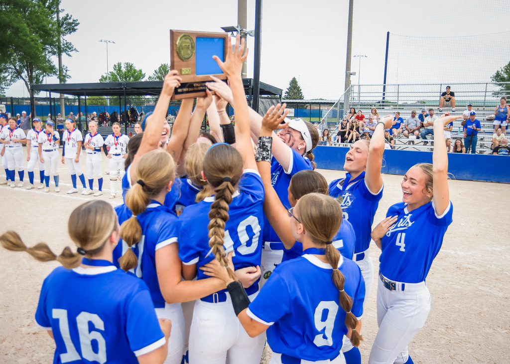 Girls holding section tournament trophy celebrating.
