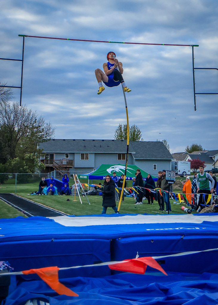 Pole Vaulter, jumping over a bar.