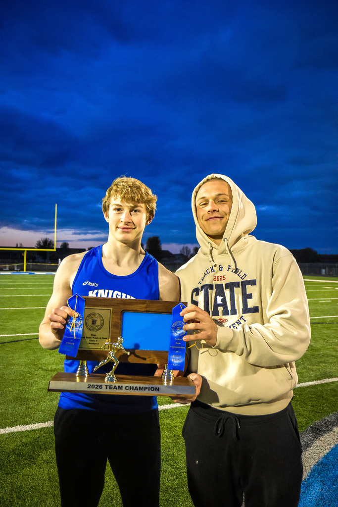 two boys holding a trophy