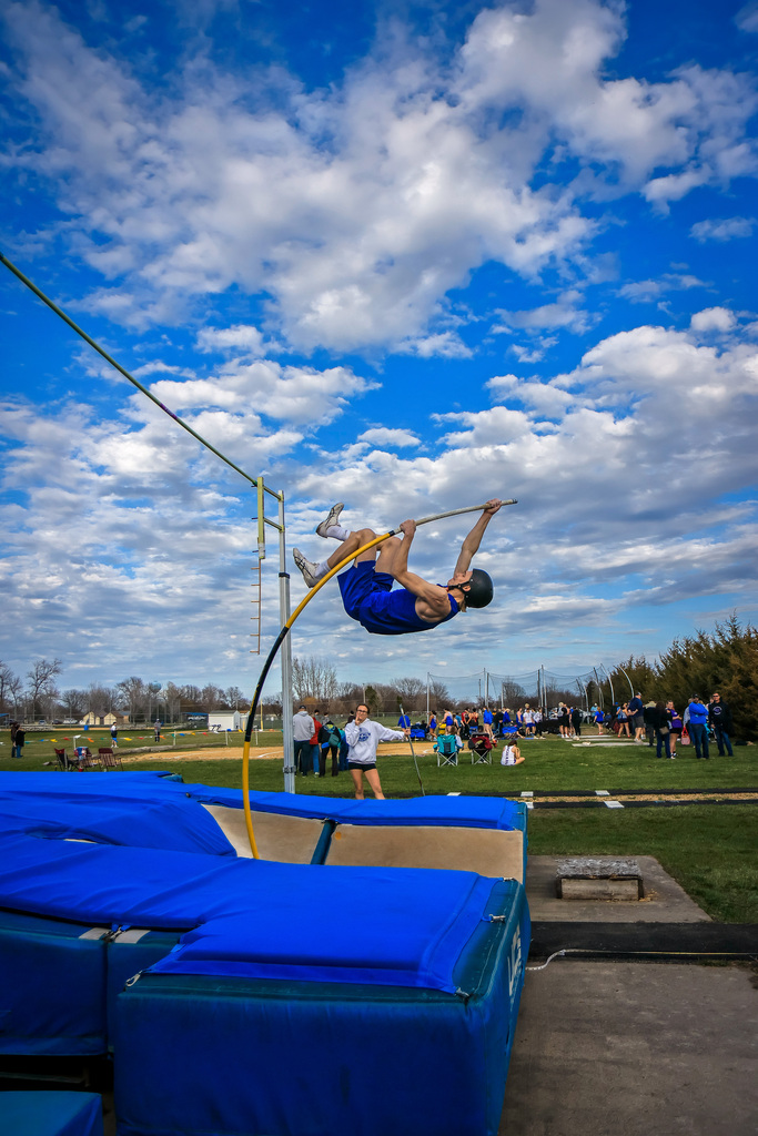 Pole Vaulter, jumping over a bar.