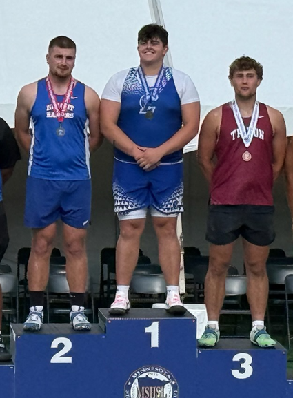 Drew Turgeon standing on the podium after getting his second place medal.