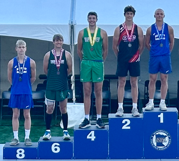 Competitors standing on the podium during an awards ceremony. 
