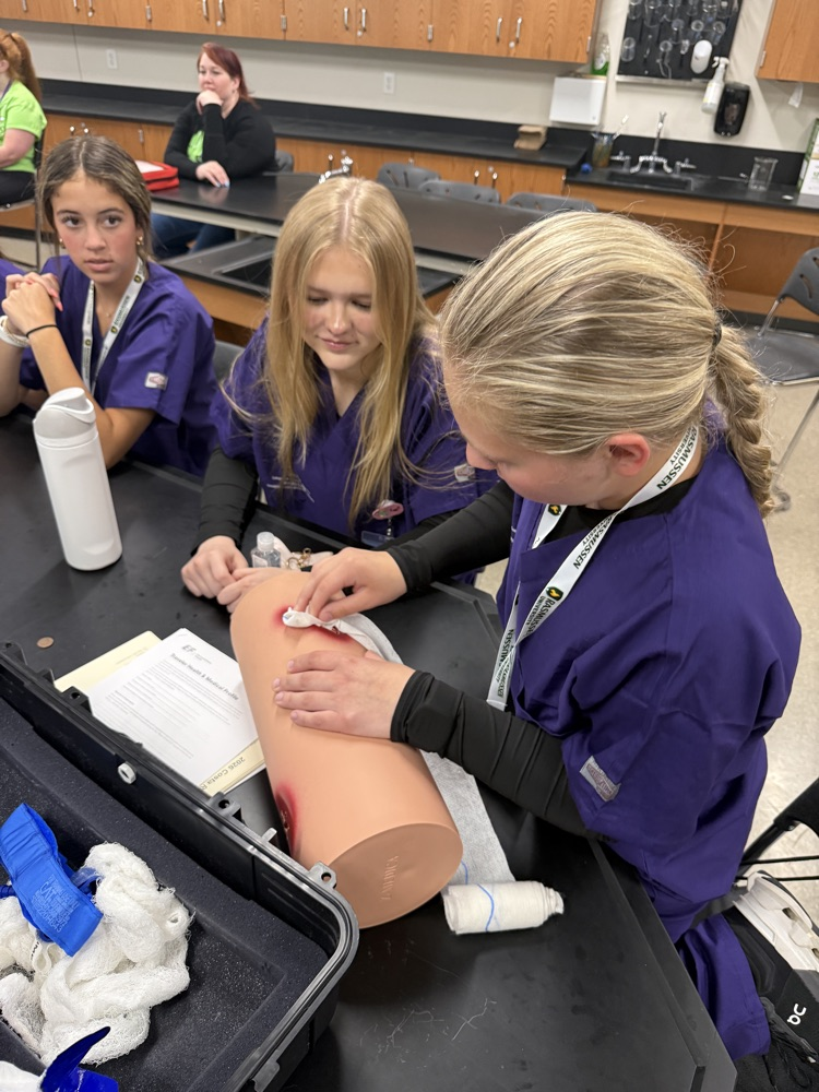 STUDENTS PRACTICING PACKING A WOUND  