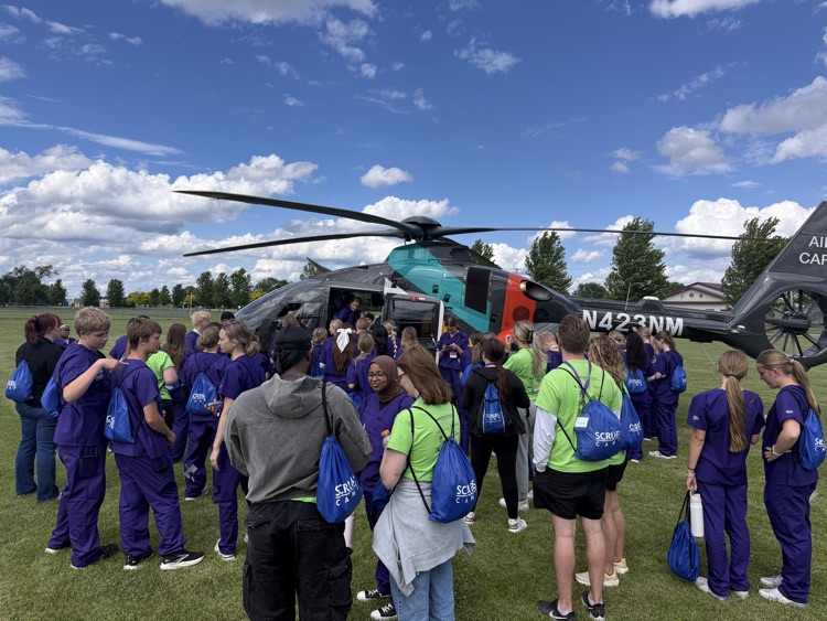 students looking at the north memorial air care helicopter 