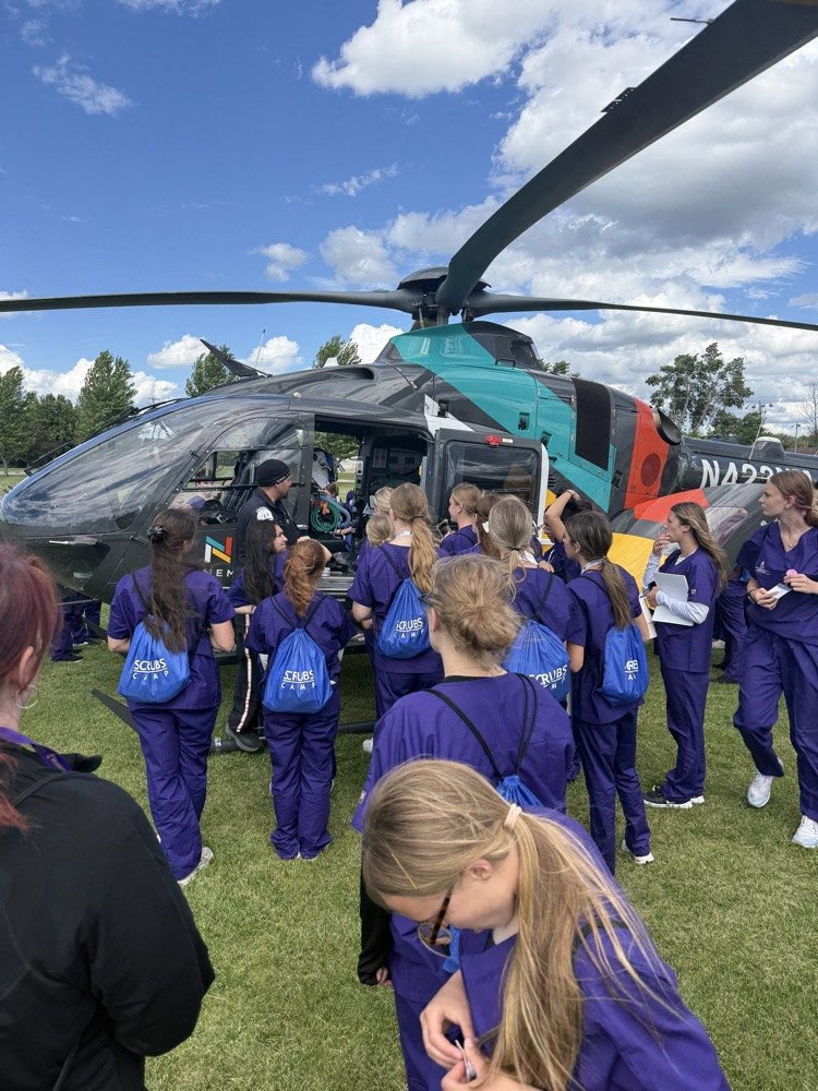 students looking at the north memorial air care helicopter 