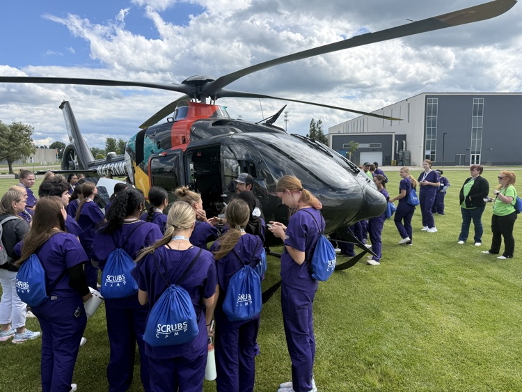 students looking at the north memorial air care helicopter 