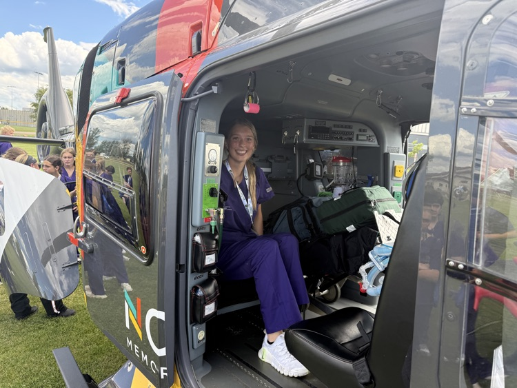 students looking at the north memorial air care helicopter 