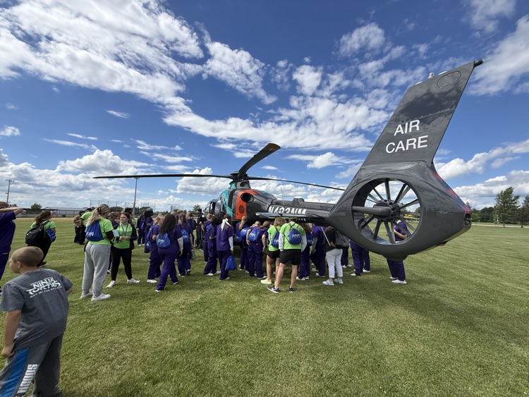 students looking at the north memorial air care helicopter 