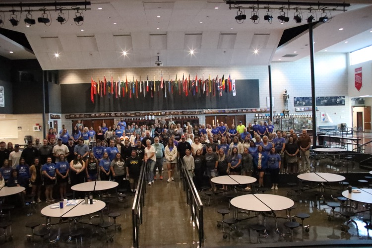 all staff in the cafetorium looking at camera