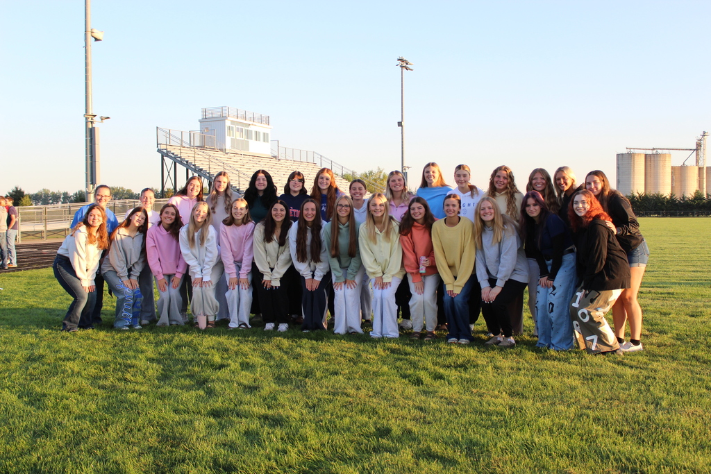 Senior girls posing and looking at the camera during senior sunrise. 