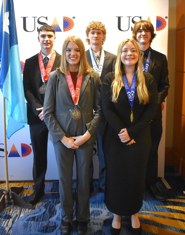 the five national medal winner students standing and looking at the camera smiling.
