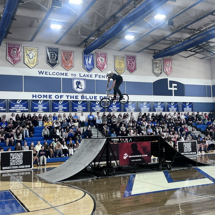 people doing bike stunts in a gym
