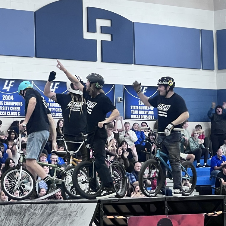 people doing bike stunts in a gym