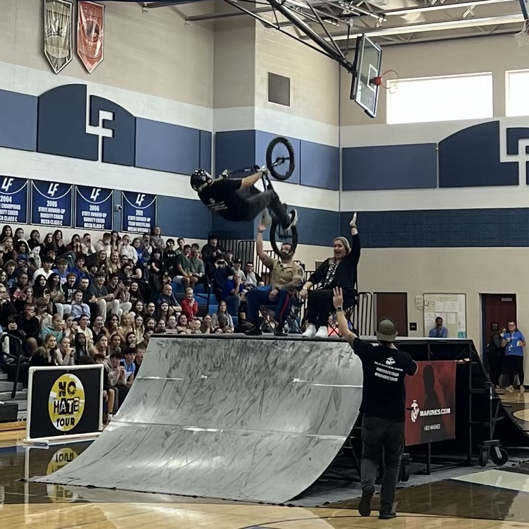 people doing bike stunts in a gym
