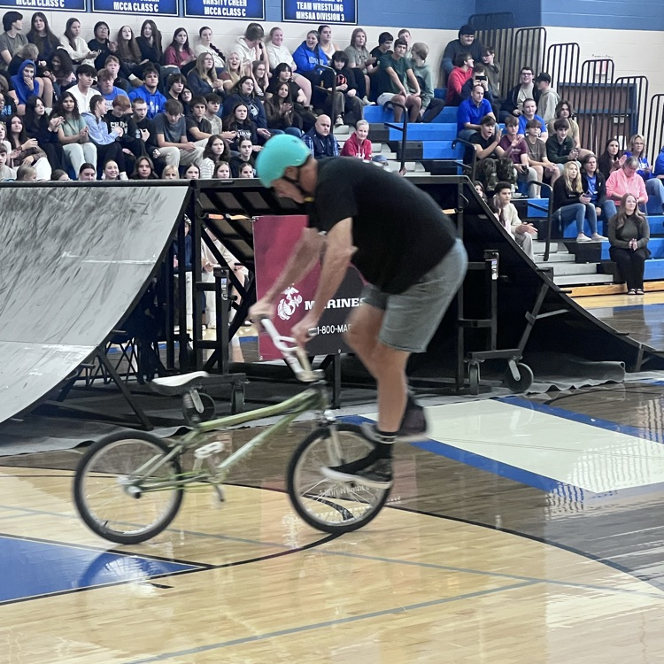 people doing bike stunts in a gym