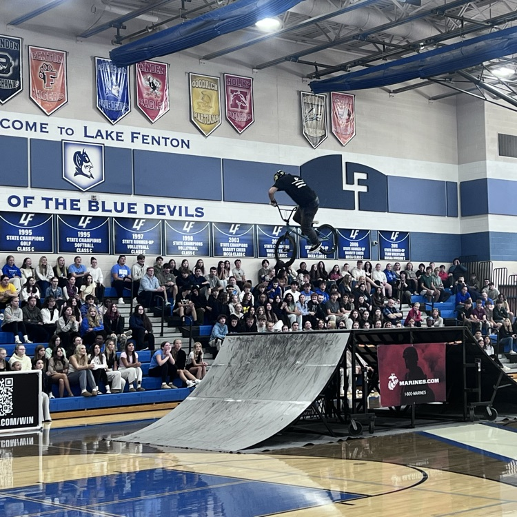 people doing bike stunts in a gym