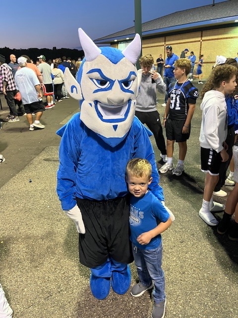 boy posing with a blue devil