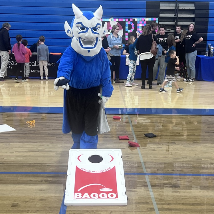 blue devil playing bean bag toss