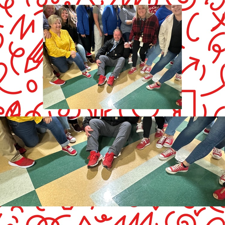 staff posing with principal in red shoes