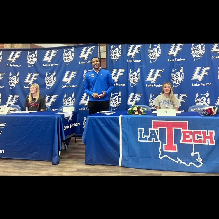 2 girls signing contracts 