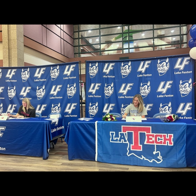 2 girls signing contracts 