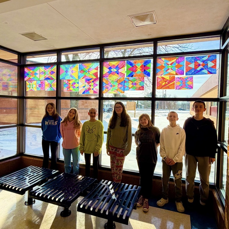 students standing in front of home made stained 